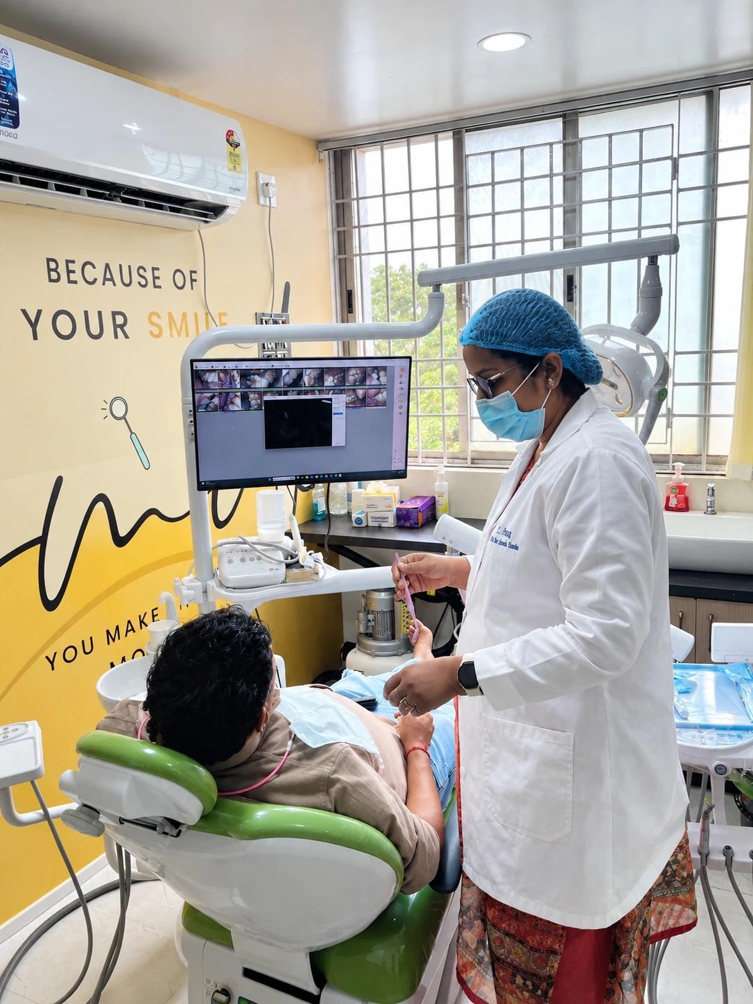 Dr. Ananya going through intraoral camera images on screen with a patient in the chair at White Oak Dental Studio, Ranchi